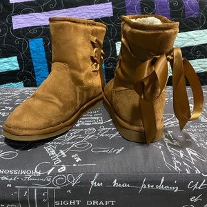 Torrid faux fur boots with laced backed bows